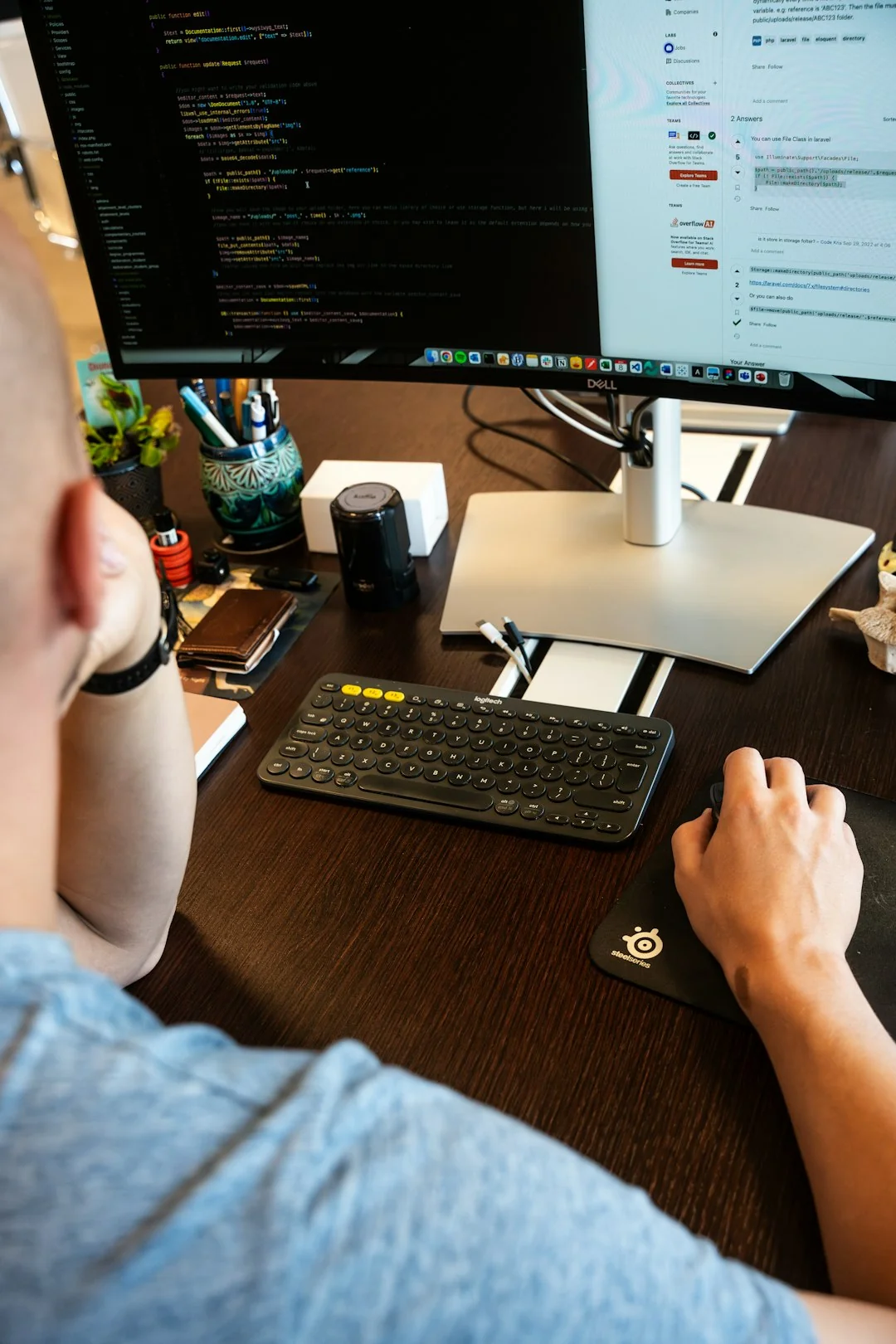 A modern workspace showing hands analyzing marketing data on a laptop and paper documents.